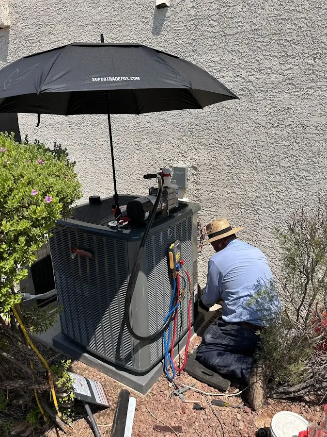 HVAC technician performing outdoor AC maintenance in Philipstown